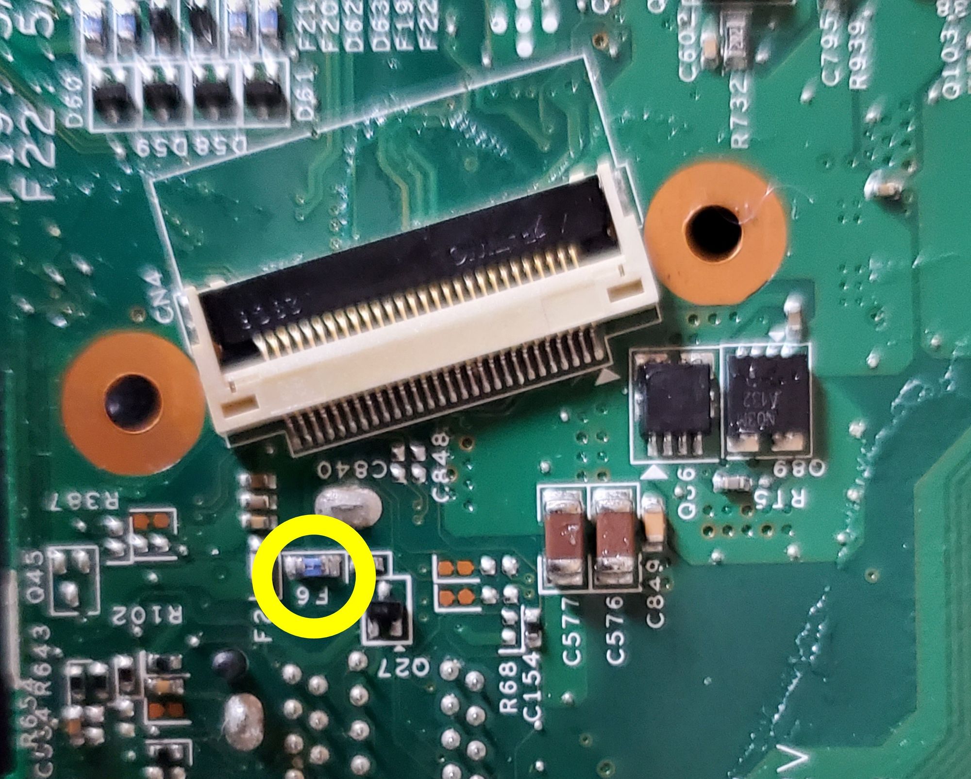 Location of fuse (yellow circle) on motherboard