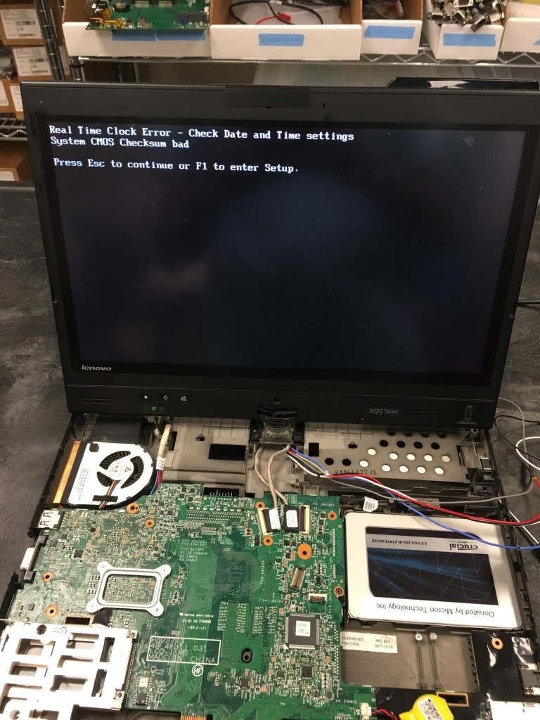 Laptop partially disassembled with working display