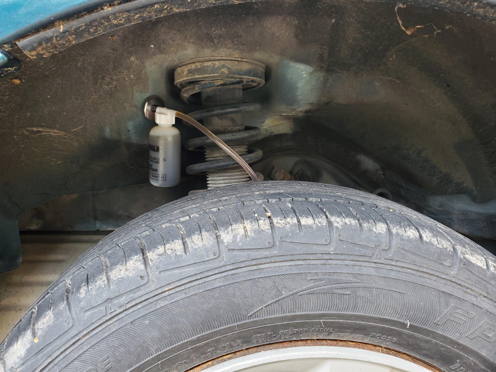 One man brake bleeder attached to a rear drum brake