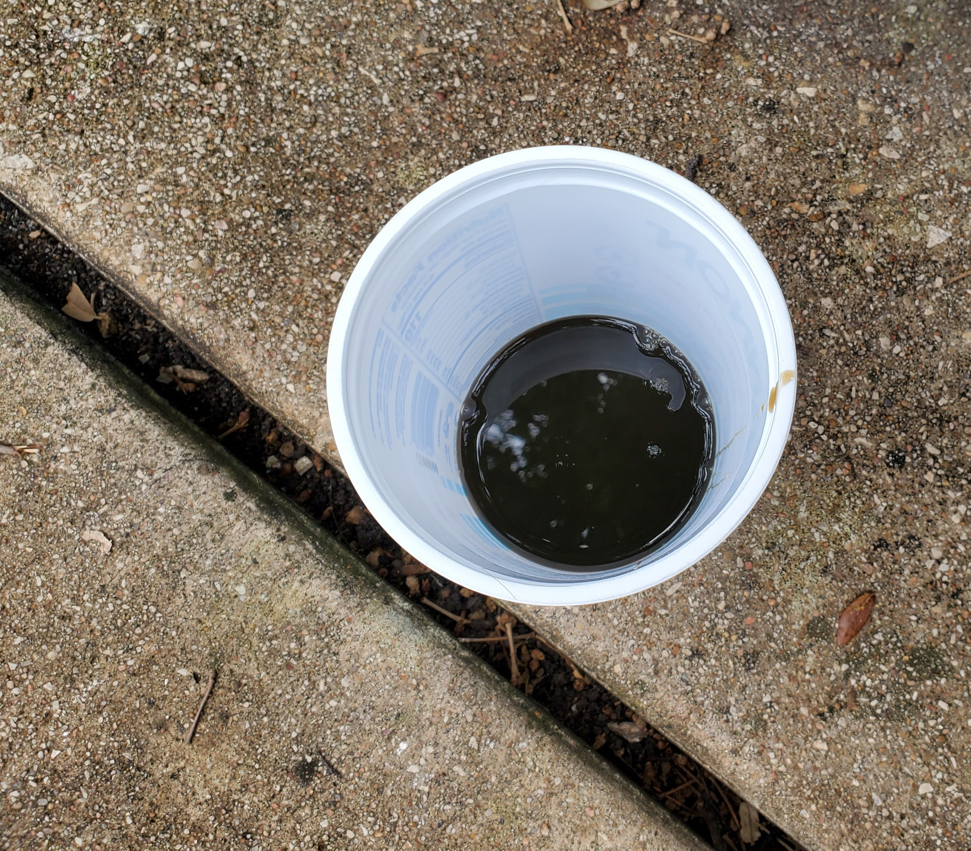 Old brake fluid, looks very black with some particles inside